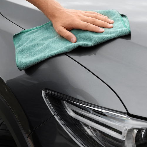 Man washing car hood sunscreen