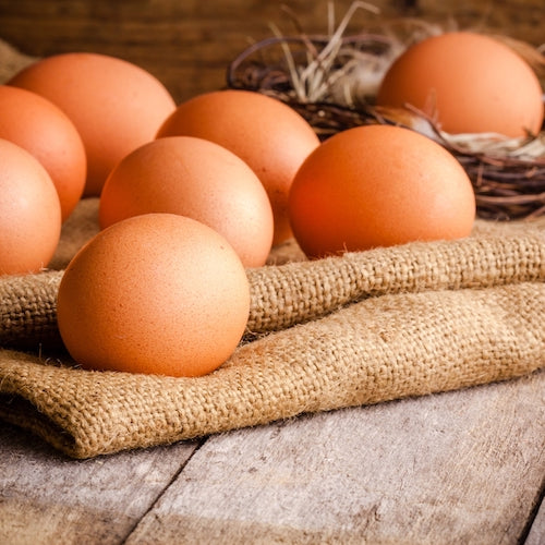 Fresh farm eggs on a wooden rustic background