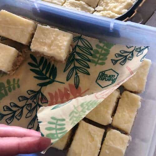 lemon coconut slice in container with honey wrap