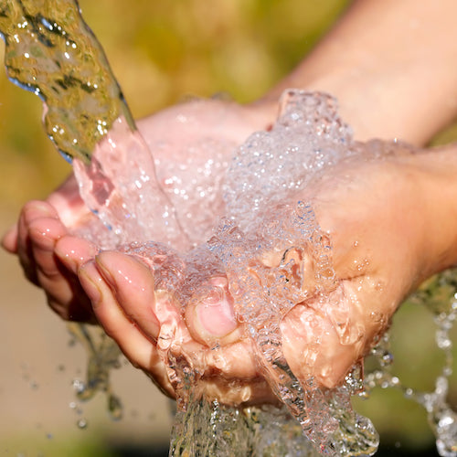 Woman's hands with water splash