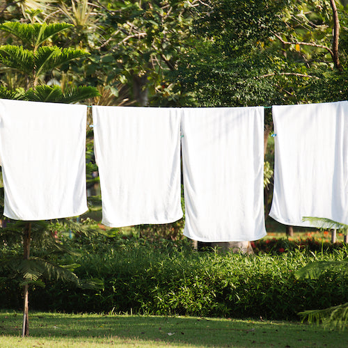 white sheets on cloths line