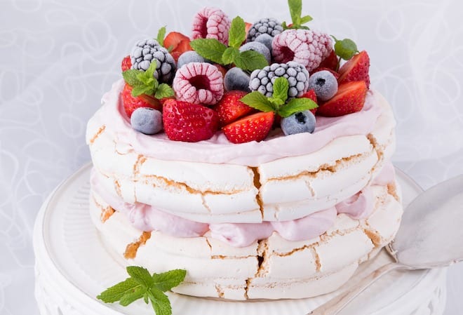 small layered eggless pavlova with vegan yogurt and berries