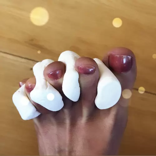 painted toes with marshmallows as toe separators