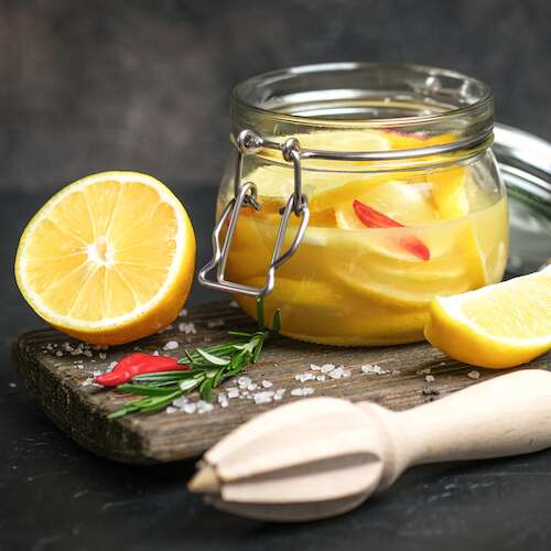preserved salted lemons in glass jar with chilli