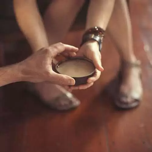 kava in coconut bowl with hands