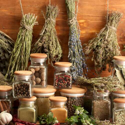 dried herbs, spices and and pepper, on wooden background