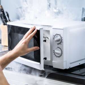 smoking microwave oven on bench