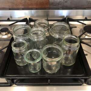 glass jars on a tray being sterilised