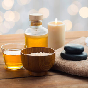 close up of epsom salt, massage oil and candle