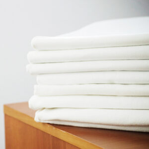 white sheets in pile